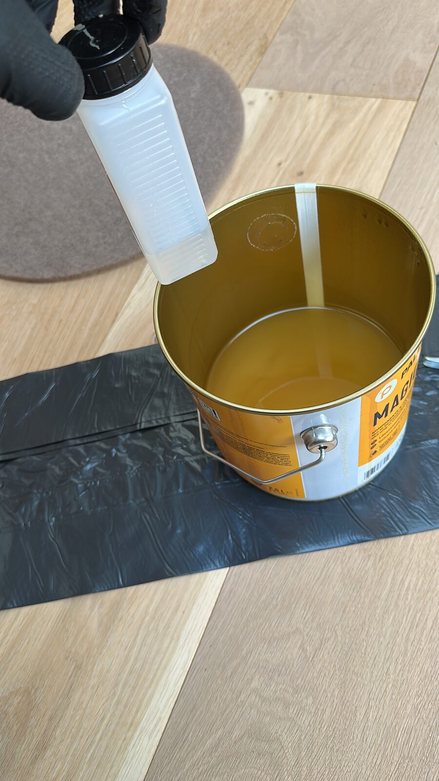 Professional oil being prepared on an oak floor