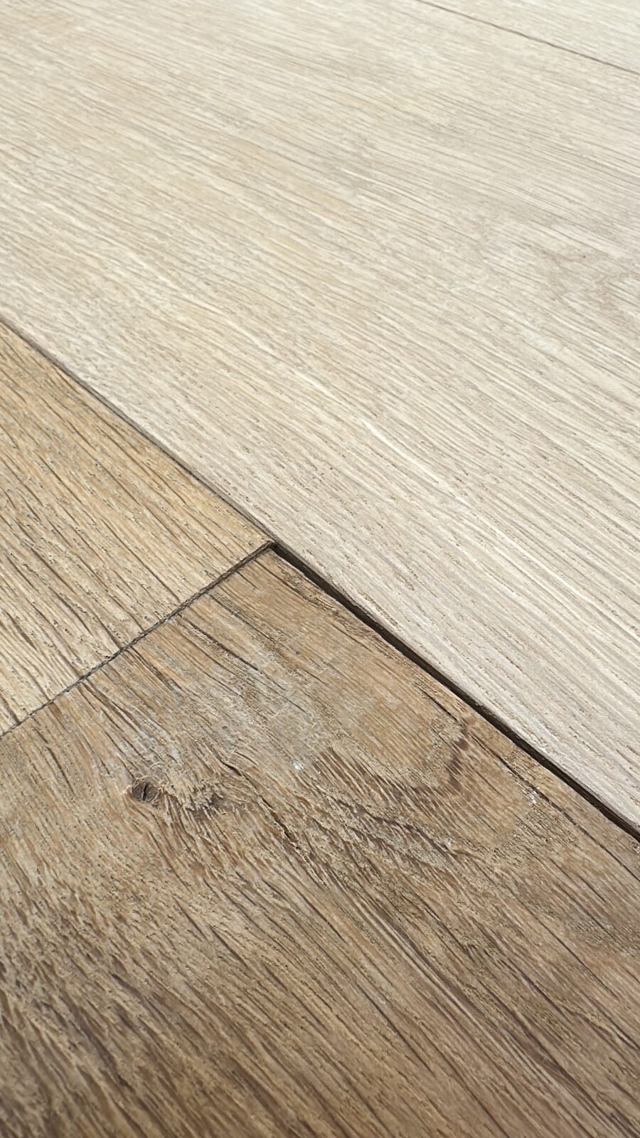 Close-up of oak grain, half raw and half sanded smooth