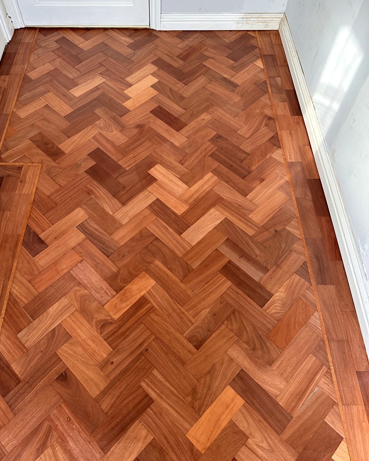 Restored herringbone parquet hallway